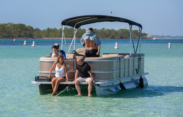 people sitting on a pontoon boat